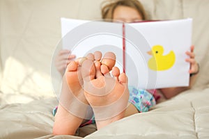 Little girl reading a book