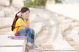 Little girl reading book thinking face