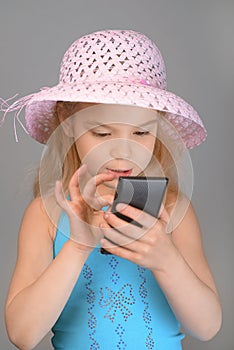 Little girl reading sms on cell phone