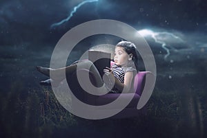 Little girl reading in storm