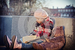 Little girl reads the book