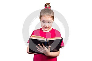 Little girl reads an old book with interest. Isolated on a white background