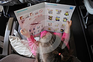 Little girl reads the safety information card