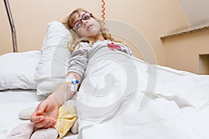 Preschooler child, patient is receiving on drip a saline