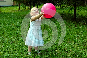 Little girl with red balloon in the forest.