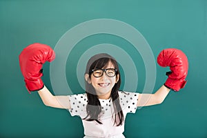 little girl with red boxing gloves before chalkboard