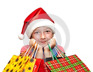 Little girl in red cap with shopping bags. Christmas