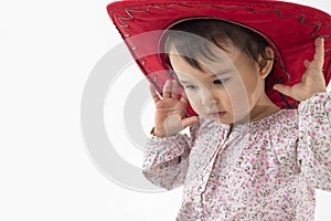 Little girl with red cowboy hat isolated on white