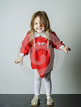 Little girl in red dress frighten photographer