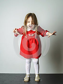 Little girl in red dress frighten photographer