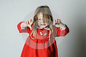 Little girl in red dress frighten photographer