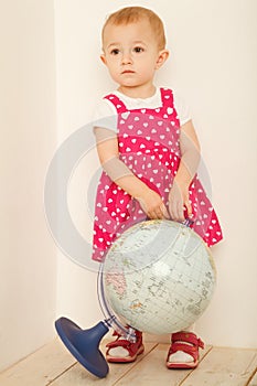 Little girl in red dress stadning at full height