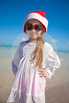 Little girl in red hat santa claus and sunglasses