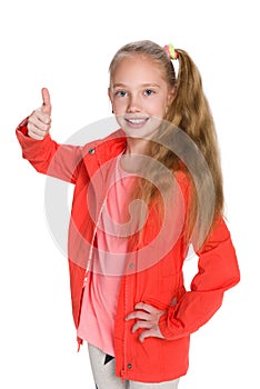 Little girl in the red jacket holds her thumb up