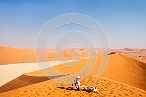 Little girl on red sand dune