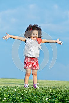 Little girl in red shorts and white t-shirt with