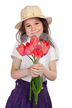 Little girl with red tulips