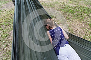 little girl relax on hammock in forest