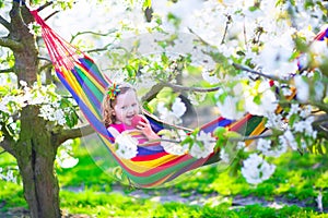 Little girl relaxing in a hammock