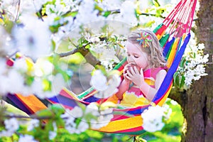 Little girl relaxing in a hammock