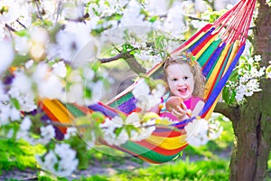 Little girl relaxing in a hammock