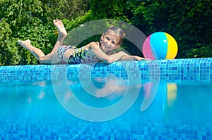 Little girl relaxing near pool, underwater and above view