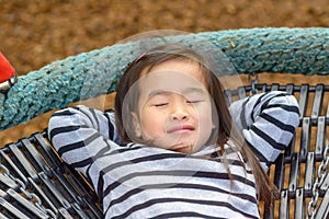 Little girl relaxing outdoors in the sun
