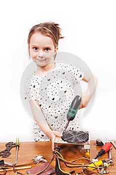 Little girl repair a computer component