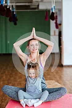 A little girl repeats exercises for her mother