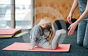 A little girl repeats exercises for her mother photo