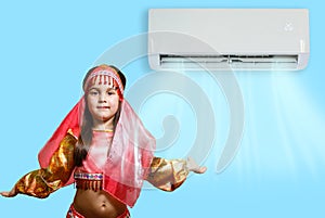 little girl resting under air conditioner on colored wall at home