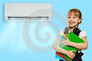 little girl resting under air conditioner on colored wall at home