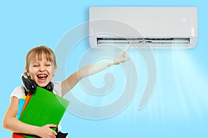 little girl resting under air conditioner on colored wall at home