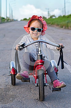 Little girl rides a bicycle