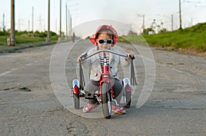 Little girl rides a bicycle