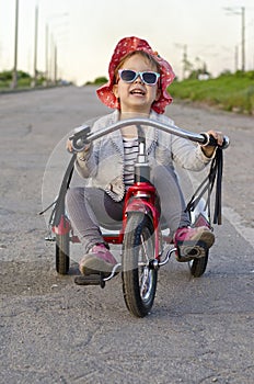 Little girl rides a bicycle