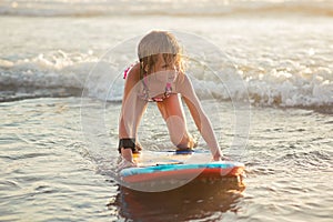 Little girl riding a boogie board