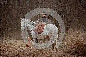 Little girl in riding habit with horse and vizsla