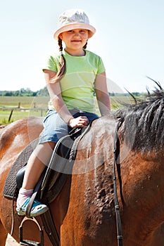 Little girl riding horse