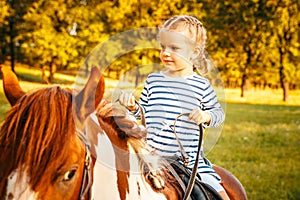 Little girl riding a horse