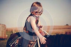 Little girl riding a horse