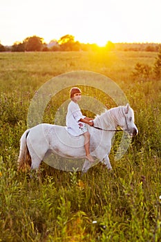 Little girl riding a horse