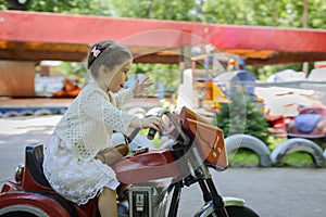 Little girl riding on motobike photo