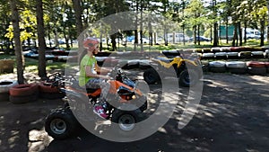 Little girl riding quad bike.