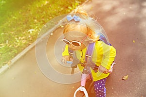 Little girl riding runbike outdoors