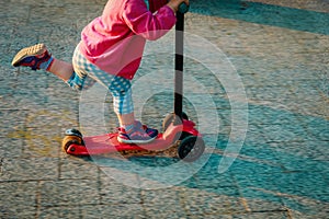 Little girl riding scooter outdoors, active kids