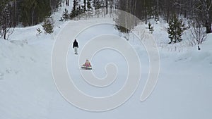 Little girl riding on a sledding tubing