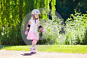 Little girl with roller skate shoes in a park