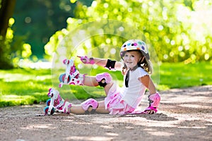 Little girl with roller skate shoes in a park