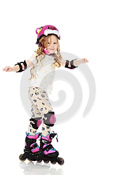 Little girl roller-skates.